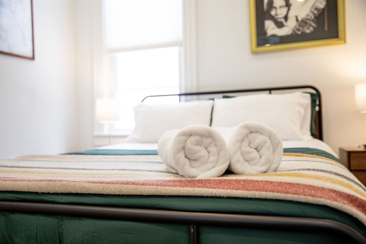 Bed, Pillows, and Towels.