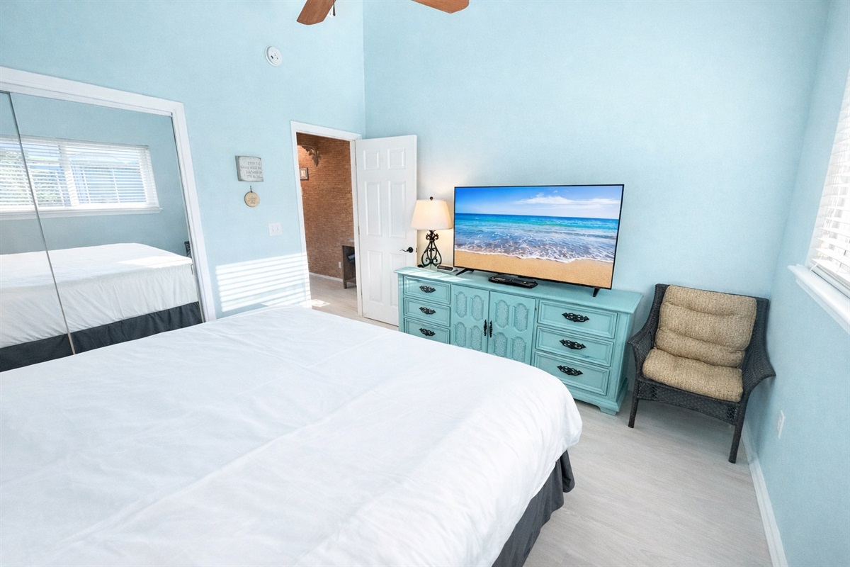 Spacious master bedroom with TV