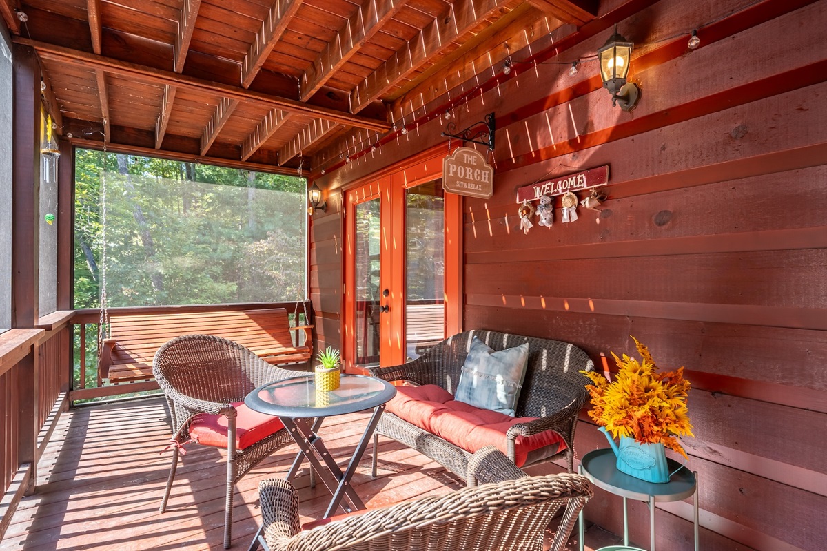 Exit the living room to the screened-in back porch with bench, 2 chairs and swing. Pesky mosquitos don't stand a chance.