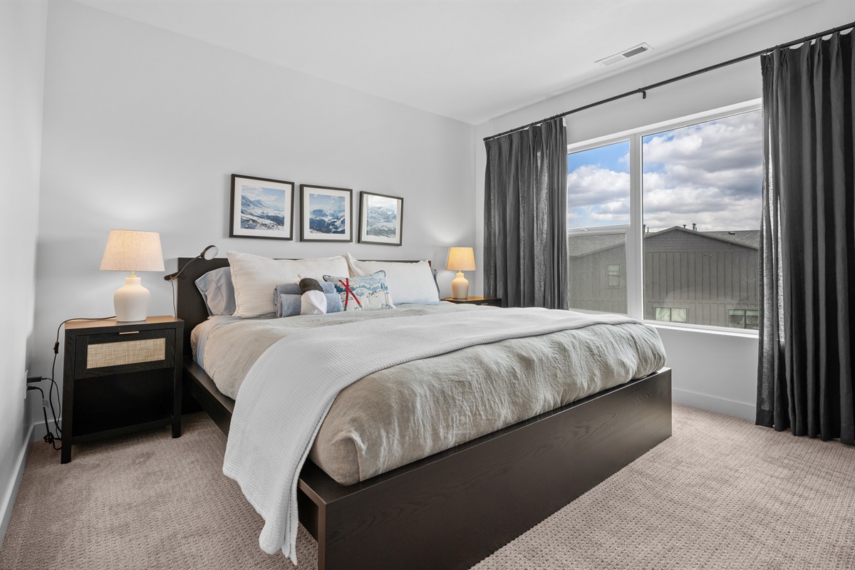 Primary bedroom with king bed and relaxing ambiance.