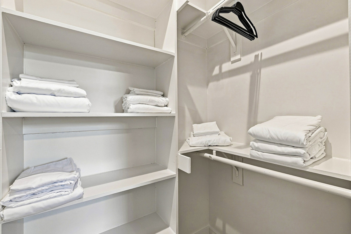 Neatly organized with fresh linens and hangers for all your travel essentials!