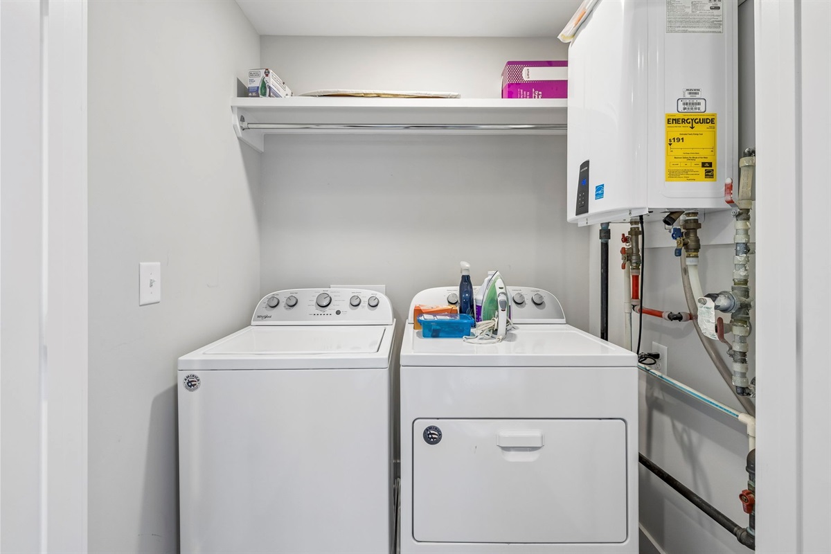 Full size washer and dryer tucked into a dedicated laundry nook for guest use - Overhead shelf provides space for detergents, supplies, and quick organization - Perfect for long stays, beach trips, or keeping fresh towels ready anytime