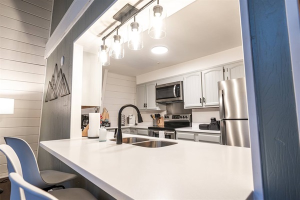 Newly renovated kitchen with bar seating for 3 and new stainless appliances