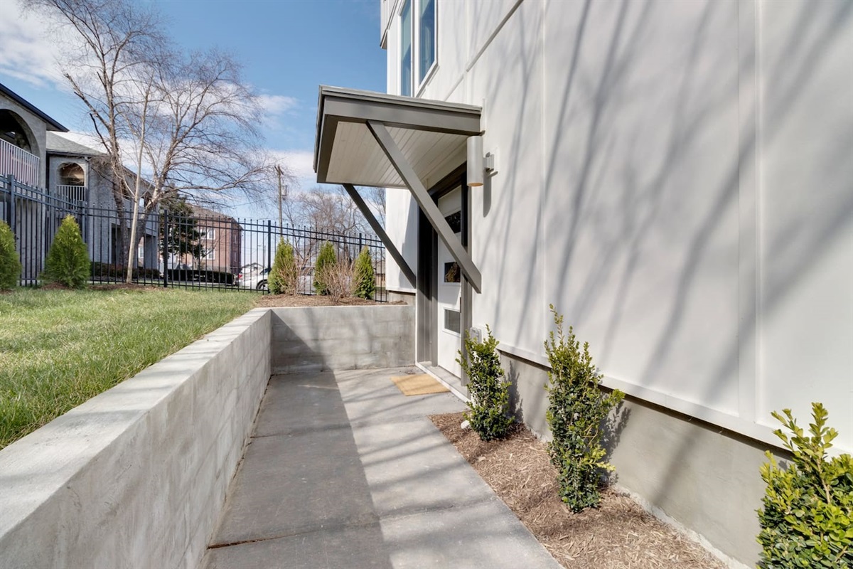 The walkway to the front door is well lit and wide