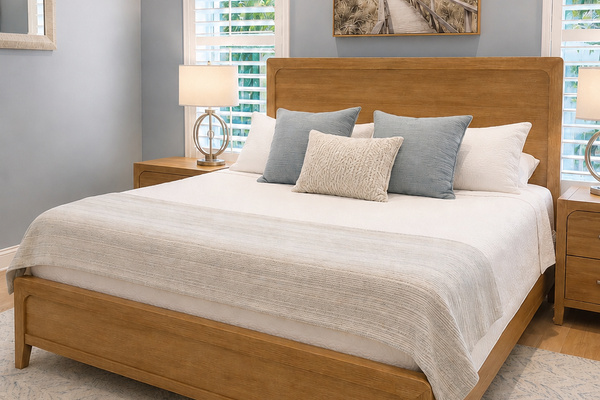 Spacious primary bedroom featuring a comfortable king-size bed and relaxing coastal style.