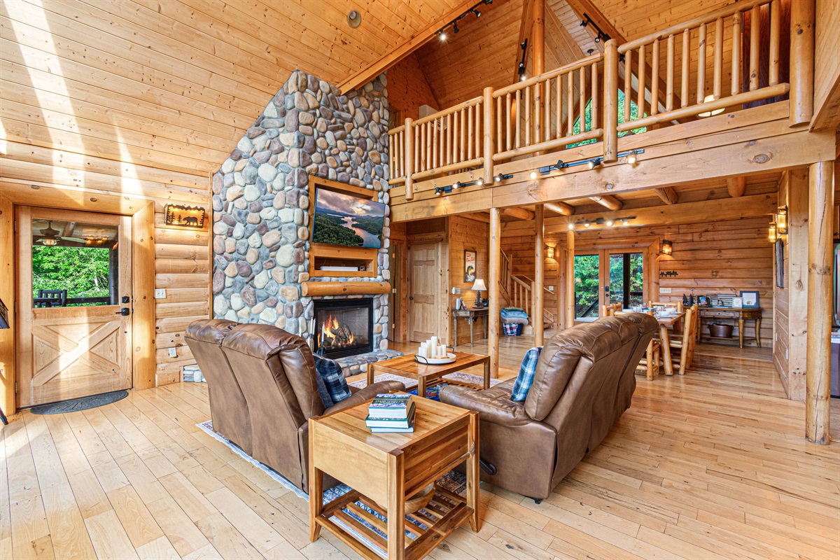 Main Level Living Room: Sun-drenched space with a stone fireplace and stunning views!