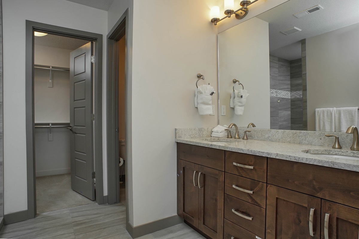 A polished primary bathroom with dual vanities and refined finishes, offering both functionality and spa-like appeal.