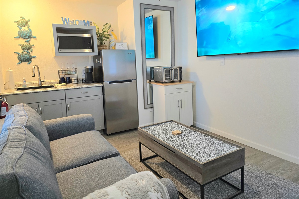 The cute kitchenette has a full sized fridge, microwave, & sink plus we've just added a moveable cart and airfry oven.  Also, Keurig, double burner with pans, dishes, crock pot, starter coffee