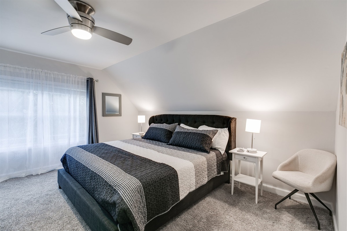 Same serene, spacious feel as our other zen room, now with crisp white furniture and a black-and-white bedspread.