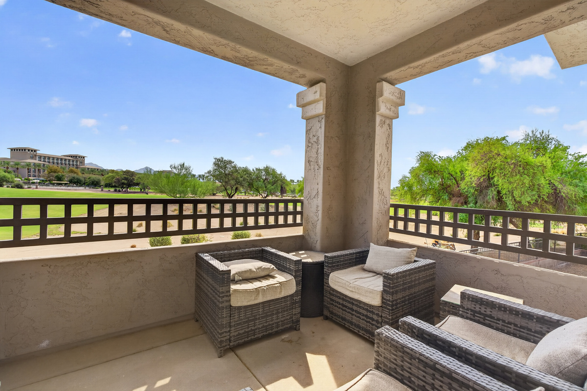 Covered balcony with outdoor seating and open desert views for coffee, reading, or fresh-air downtime.