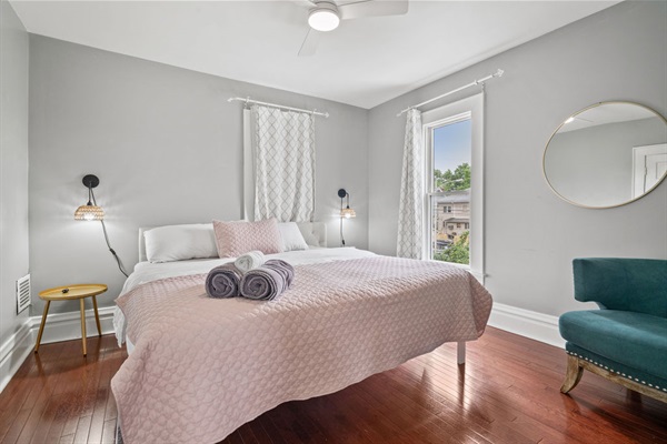 Bedroom 2:  Oversized King Bed. Smart lamps on both sides of the bed, a mirror and oversized sitting chair, and a closet for hanging your cloths.