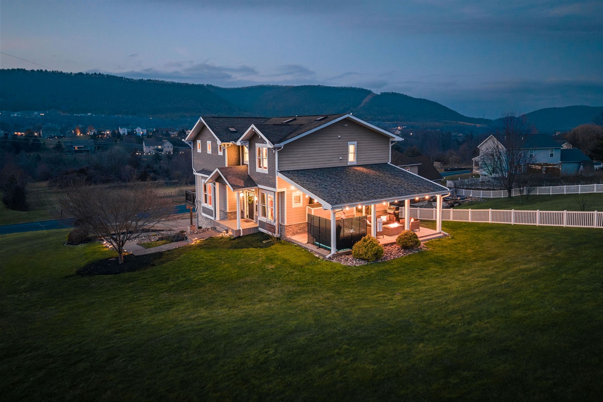 Aerial twilight view showcasing the home’s size, privacy, and peaceful setting — a rare combination just minutes from Penn State.