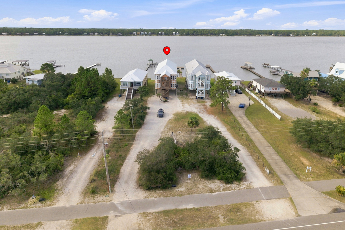 Aerial view of the home and its Little Lagoon setting