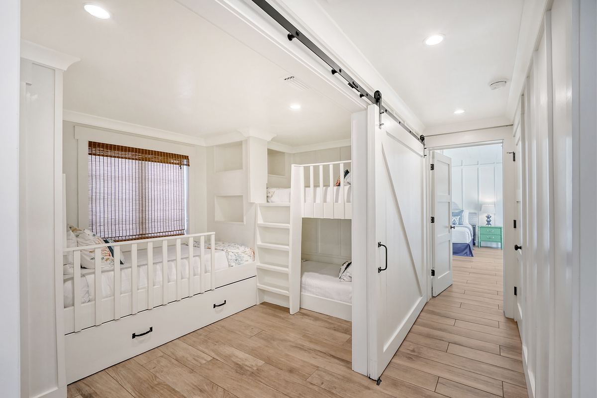 Bunk room with 4 twin mattresses.  The trundle twin is below the window bed.
