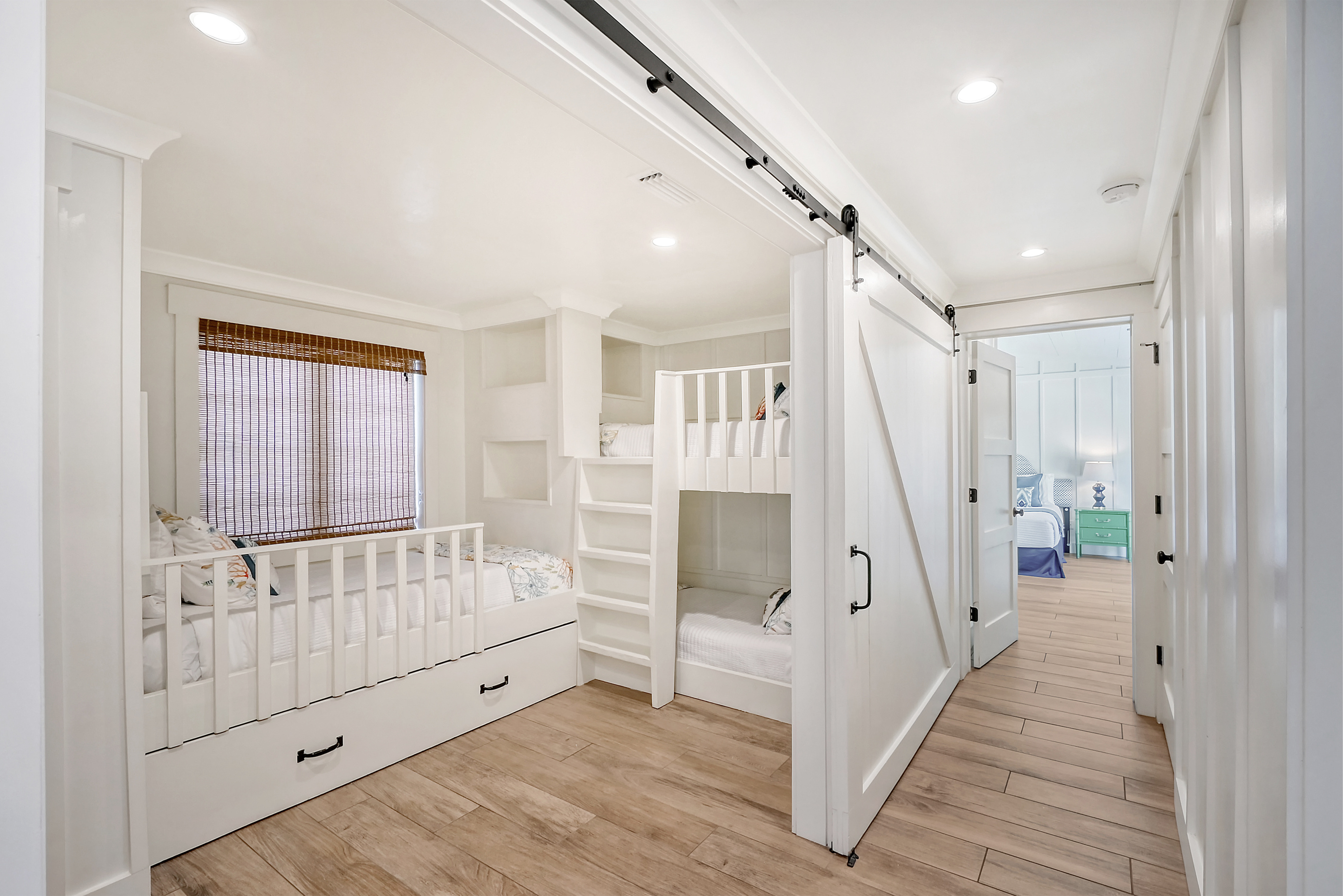 Bunk room with 4 twin mattresses.  The trundle twin is below the window bed.