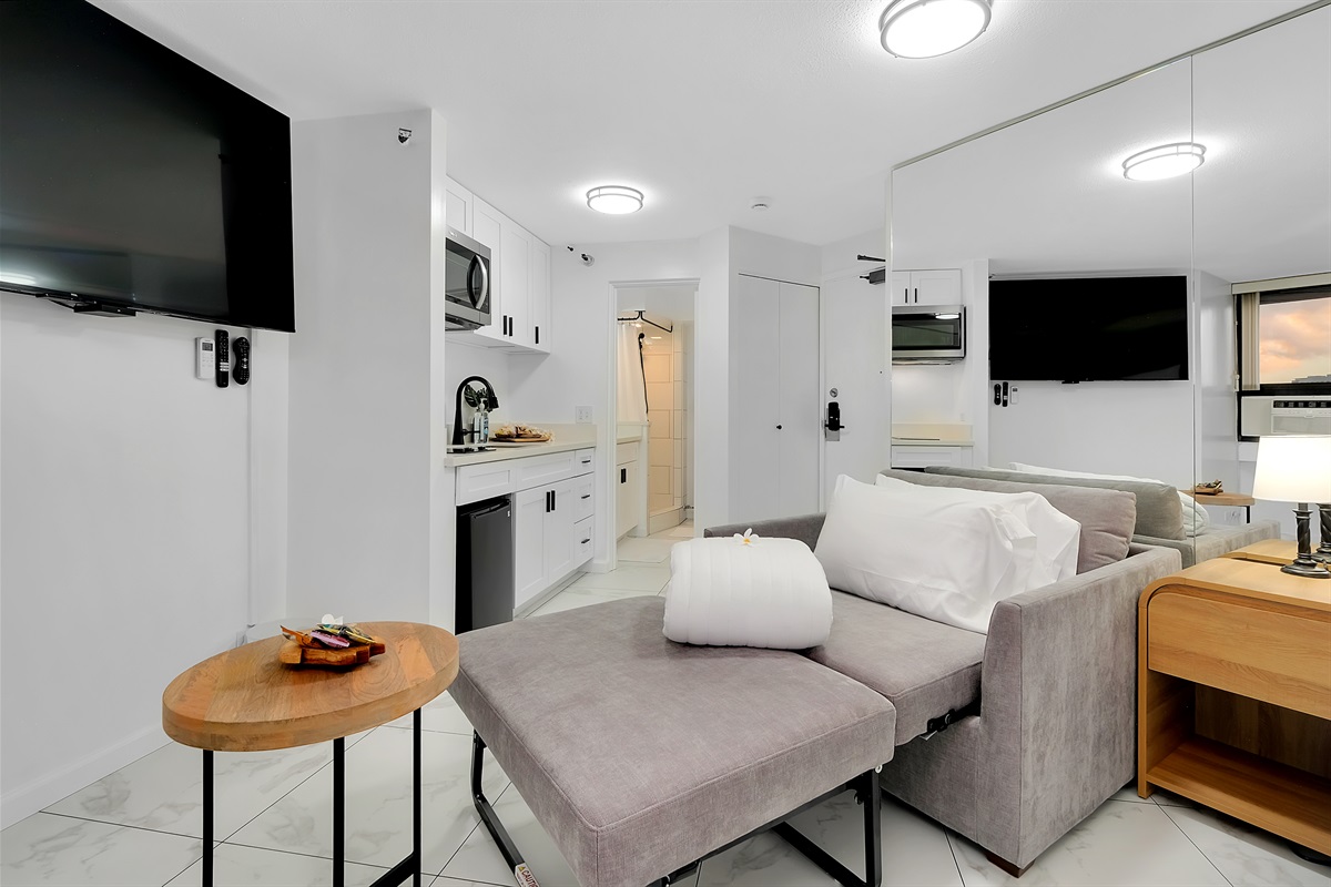 Modern comfort meets island sophistication in this thoughtfully designed Waikīkī suite. Featuring a cozy lounge area, kitchenette, and soft contemporary décor, it’s the perfect home base for relaxing after a day in paradise.