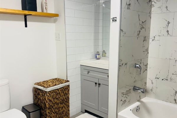 Clean bathroom with modern fixtures and guest essentials.