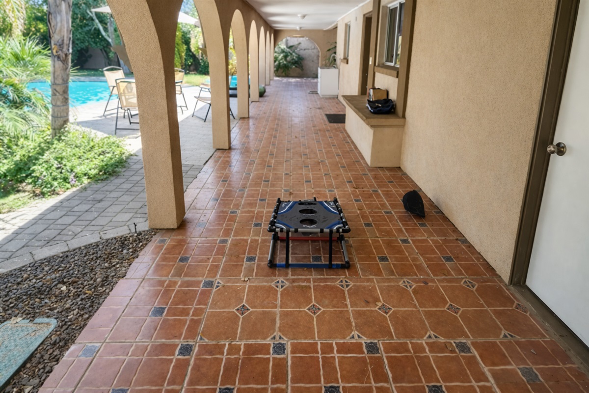 This breezy covered patio with classic tile flooring is ideal for sipping morning coffee, lounging in the shade, or enjoying the desert breeze.