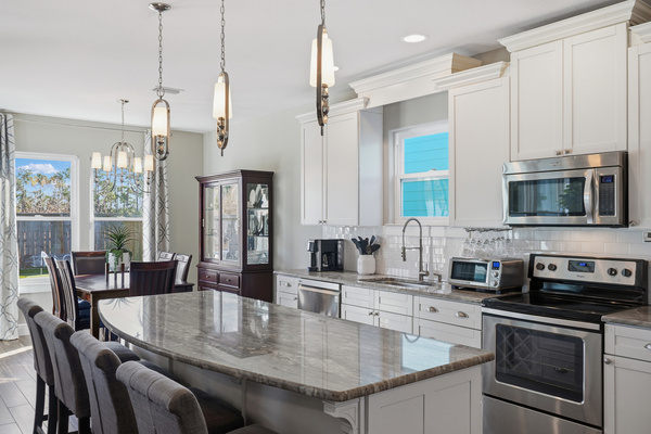 Large kitchen island and open layout in this Panama City Beach house with a private pool.