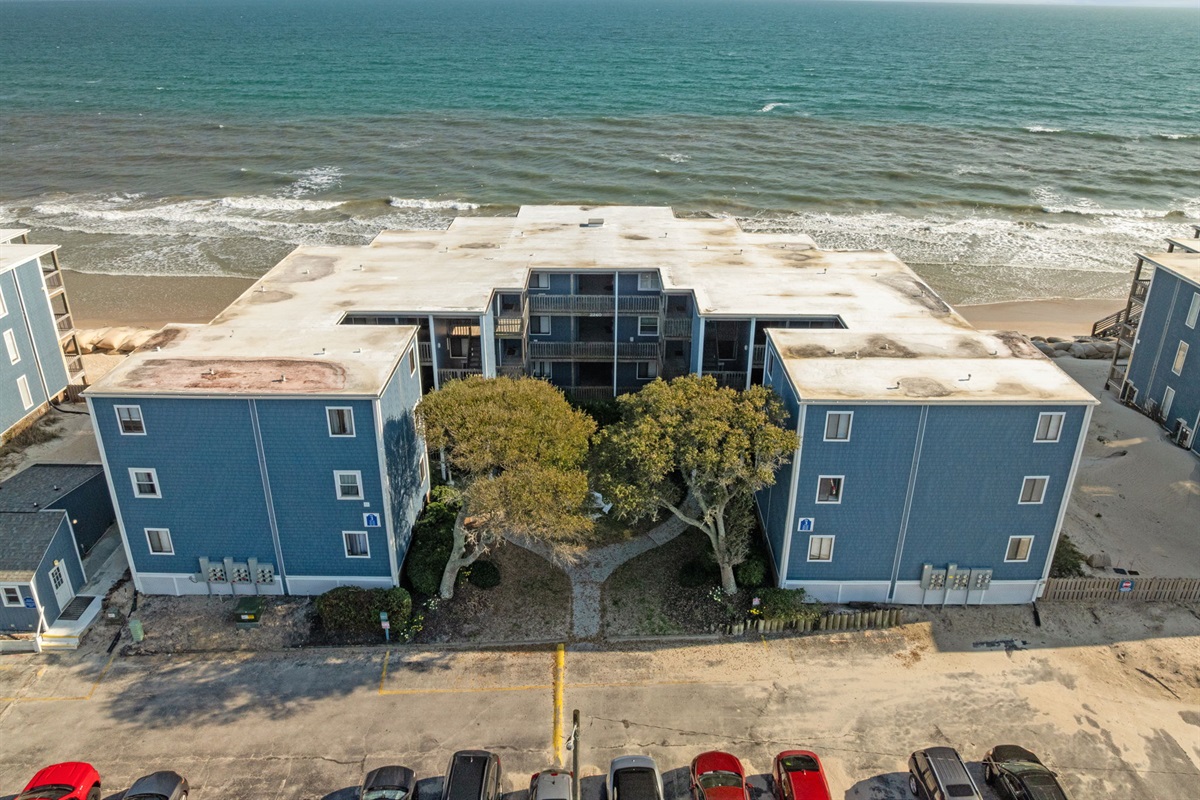 Aerial view of the oceanfront building with the beach just steps away