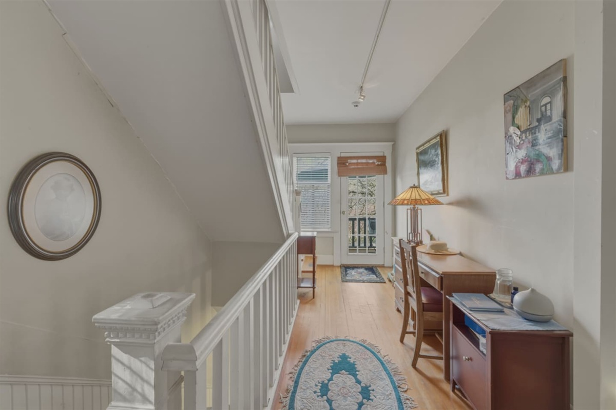 Second floor hallway showing door to the outdoor balcony
