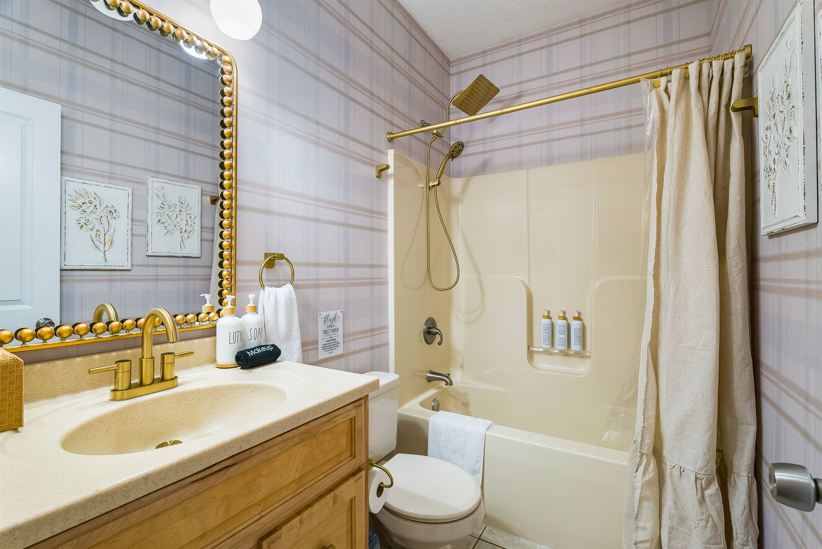 A bright, clean bathroom with gold accents and everything you need to refresh and recharge.