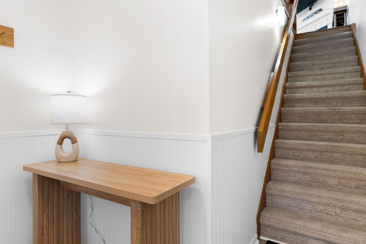 Your arrival starts here &mdash; walk through the foyer, head up, and the cottage opens into everything you came for.