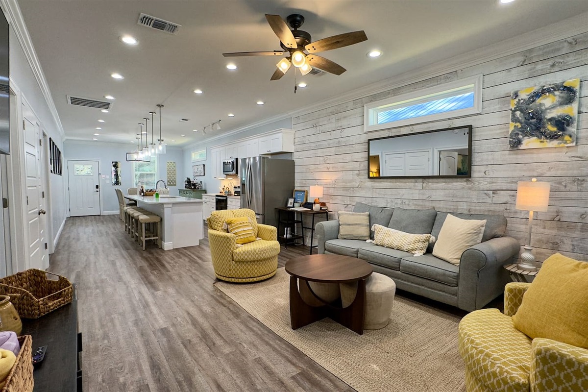 Where sleek design meets cozy charm—living room and kitchen in harmony