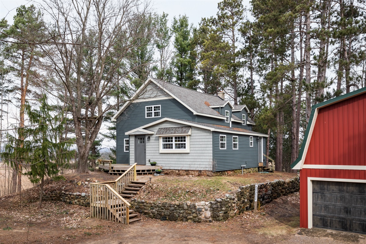 The red barn next to the house is the garage.