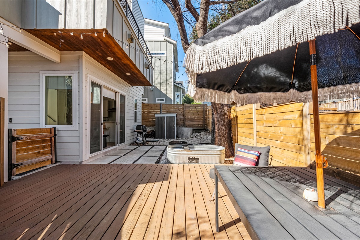 Spacious private patio with deck seating and a fenced outdoor setting