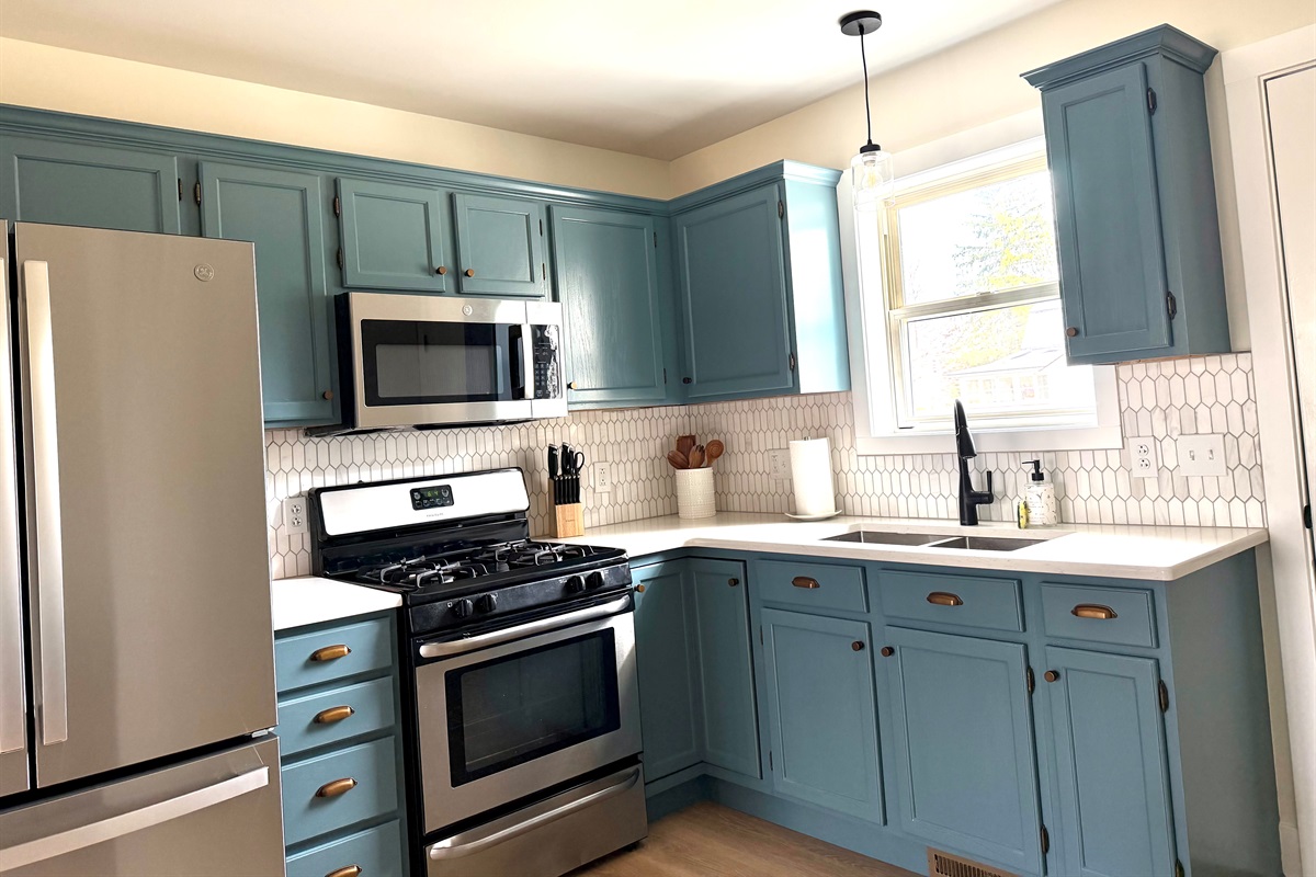 Fully equipped kitchen featuring new appliances, quartz countertops, and everything you need—including pots, pans, cooking utensils, and basic spices