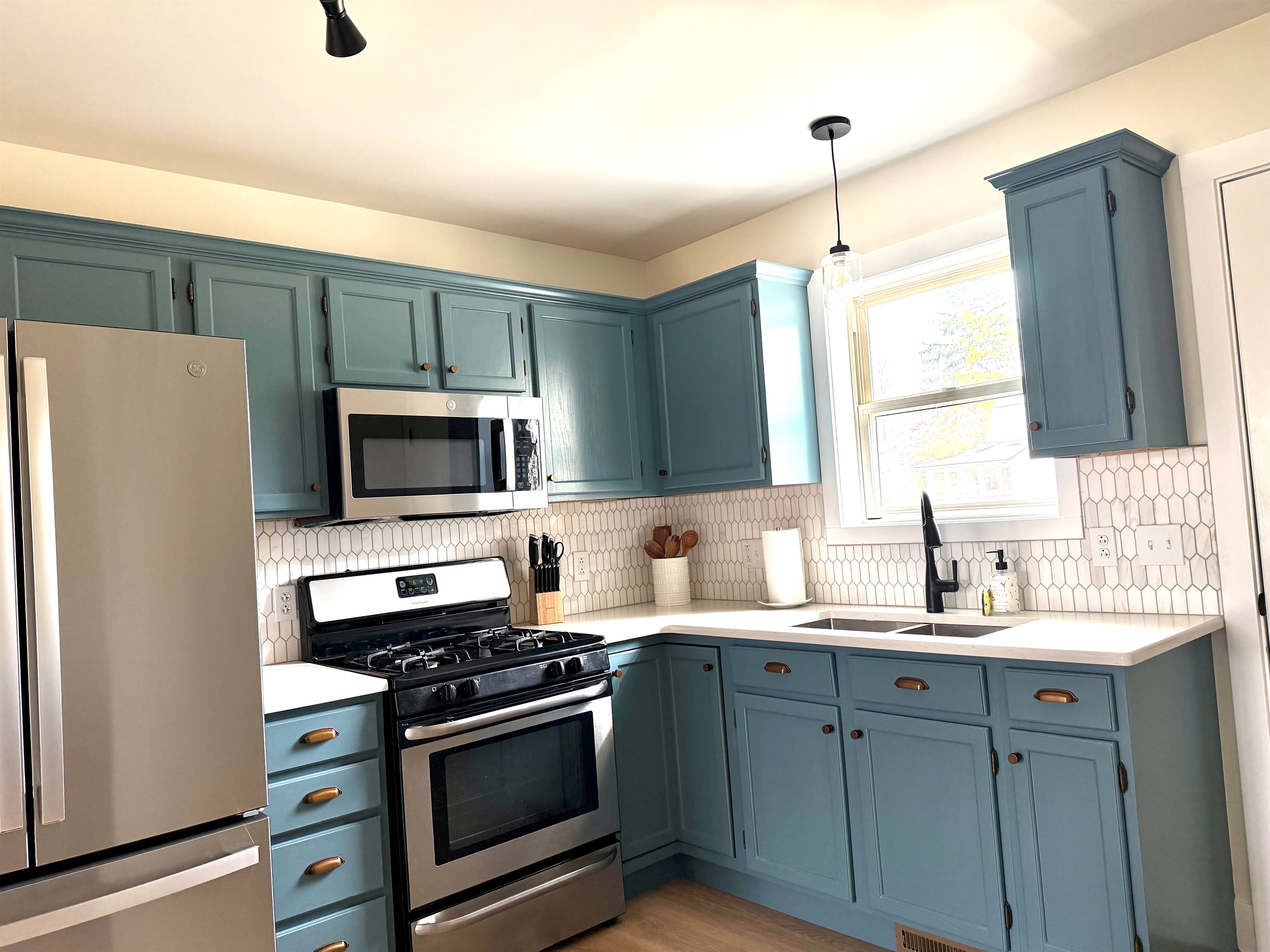 Fully equipped kitchen featuring new appliances, quartz countertops, and everything you need—including pots, pans, cooking utensils, and basic spices