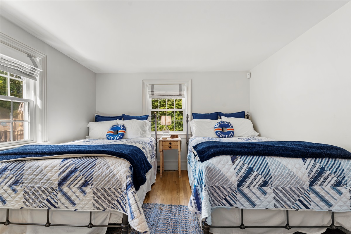 Rest easy in our room with two plush double beds, designed for relaxation.