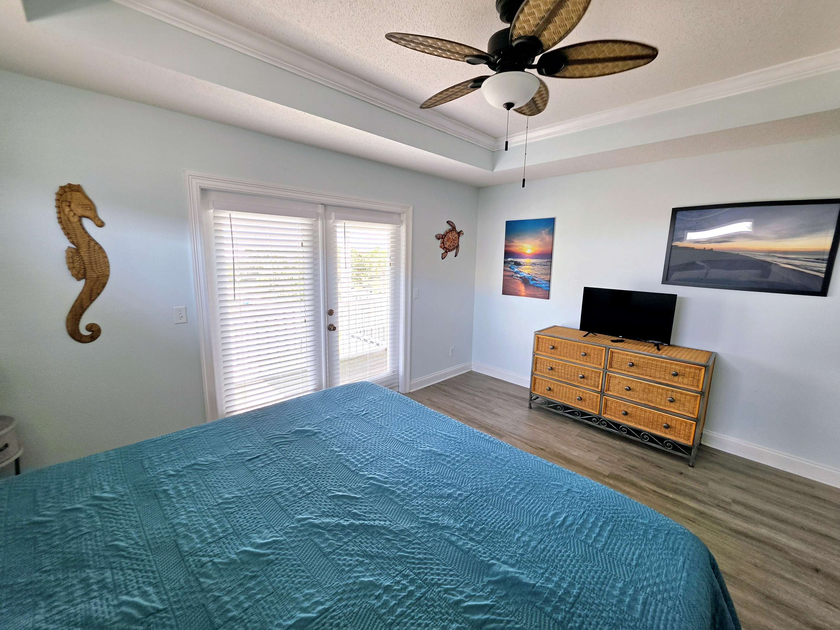 Primary bedroom with TV and ceiling fan
