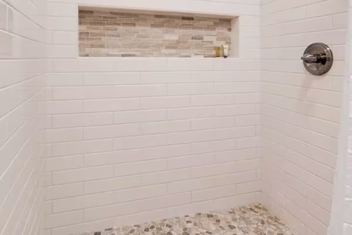 Spacious walk-in shower with modern finishes.