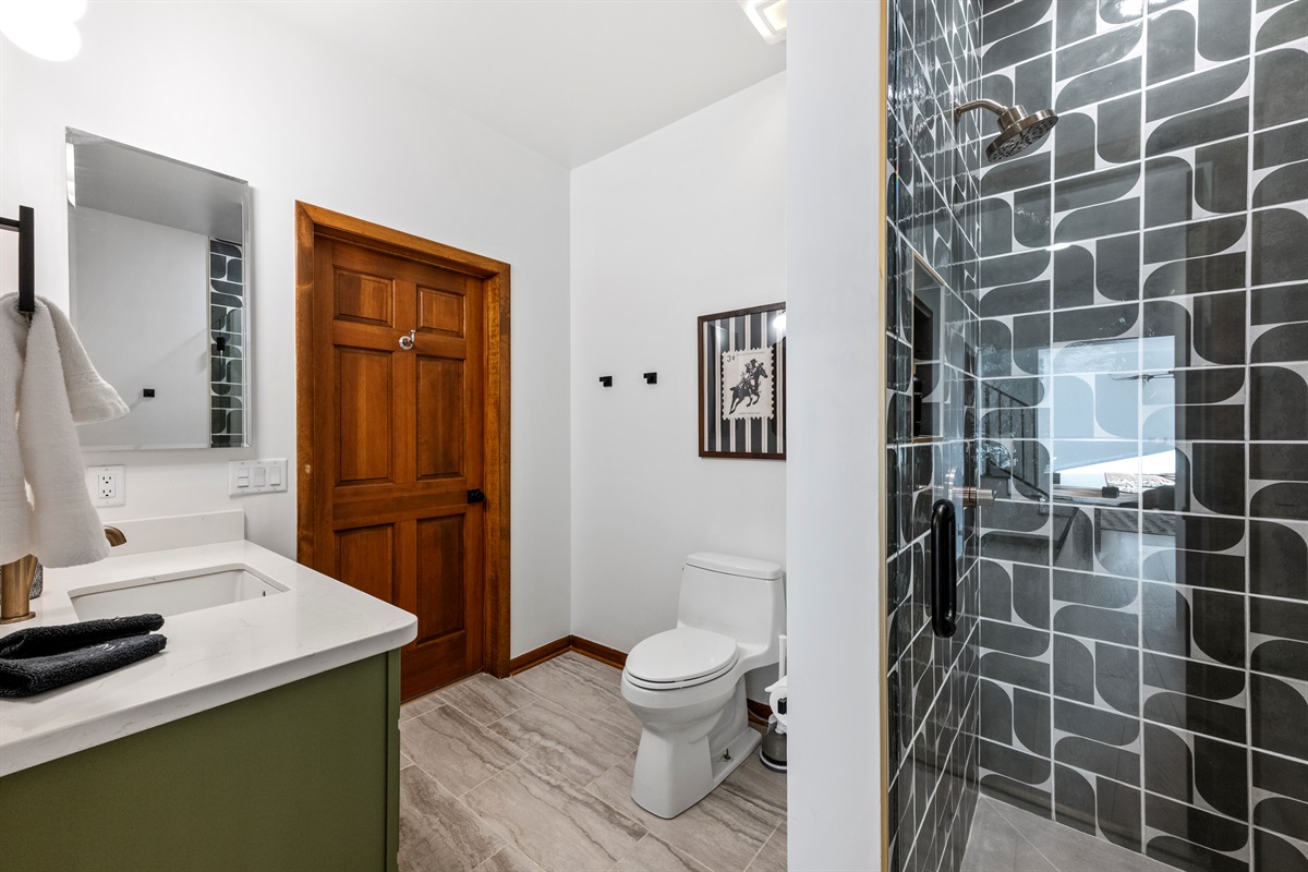 Bathroom 4:
Refreshing space featuring a spacious walk-in shower and striking designer tile. (Downstairs)