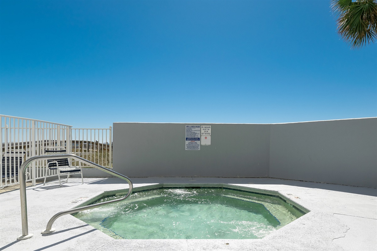 This charming outdoor space features a soothing hot tub and easy access to the pool, creating an ideal vacation retreat.