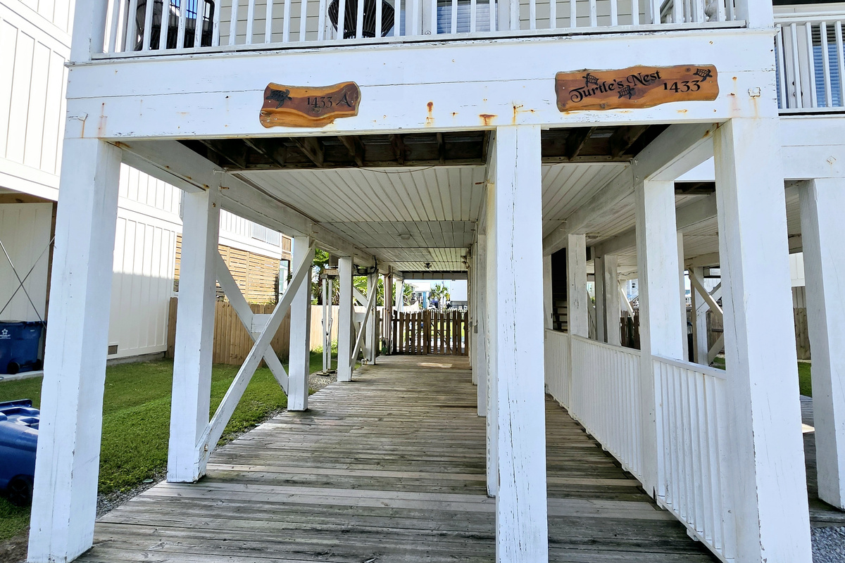 Shaded ground-level deck beneath the home