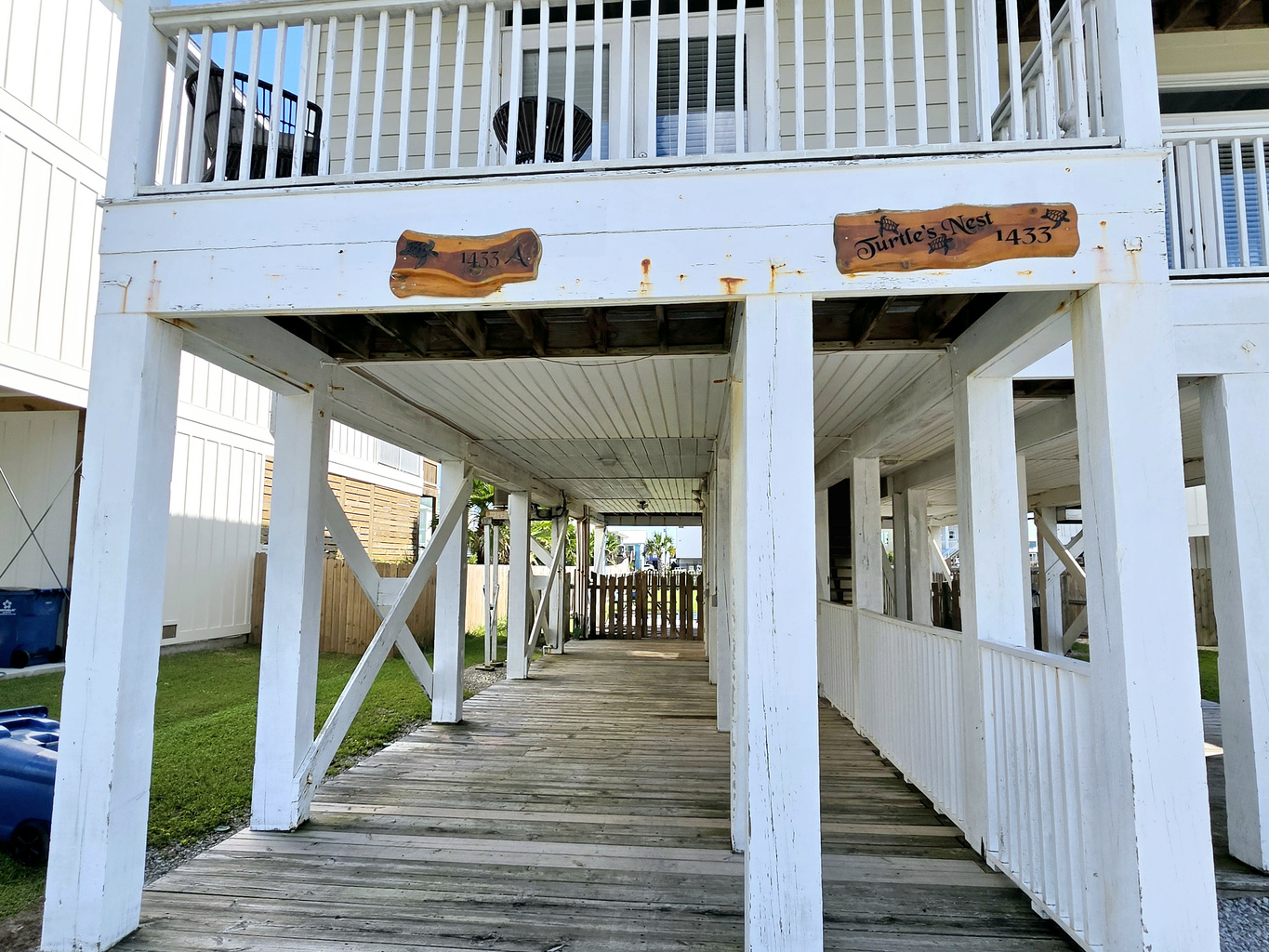Shaded ground-level deck beneath the home