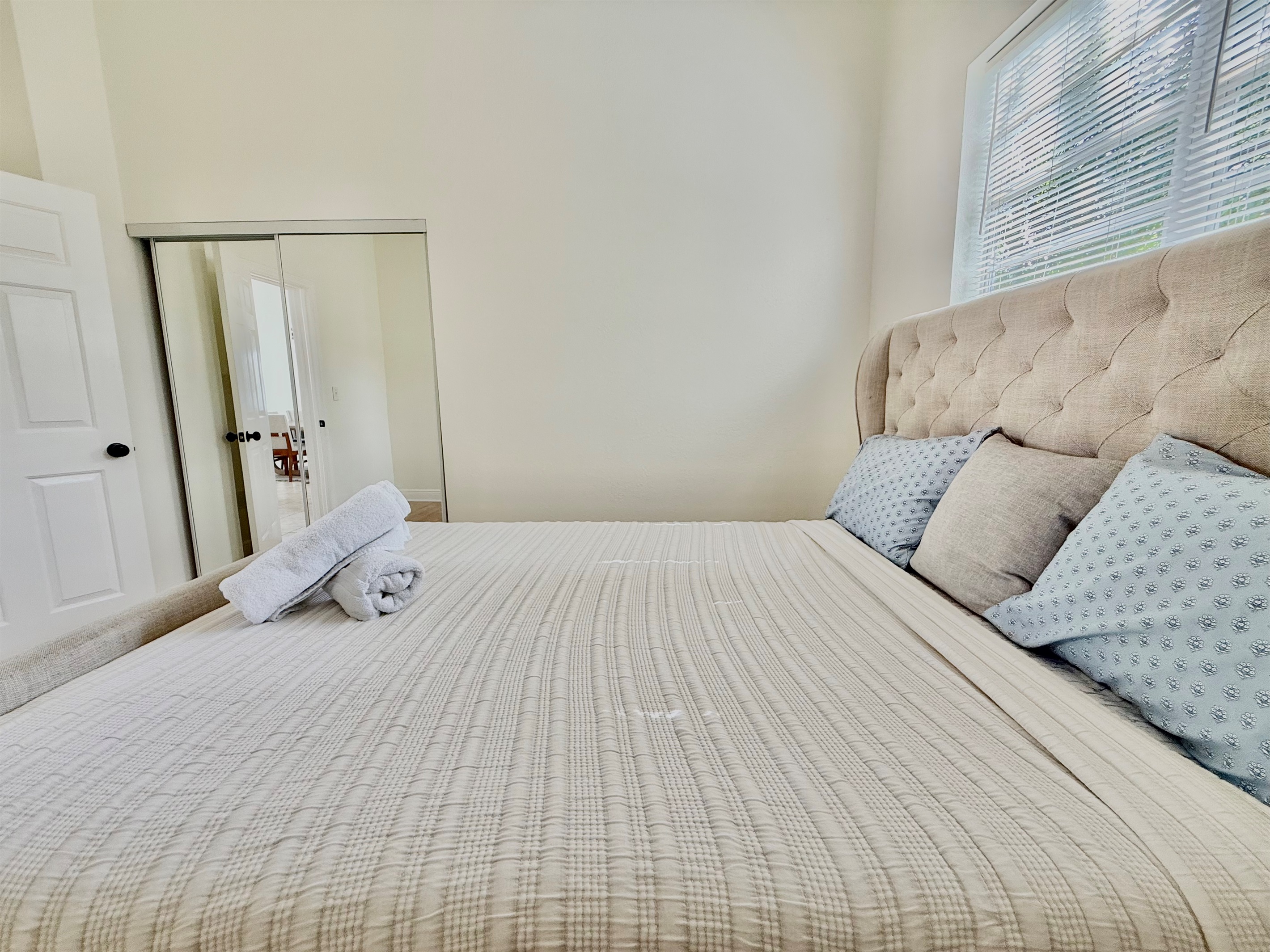 A sophisticated upholstered bed anchors this peaceful retreat—ideal for curling up with a book or getting a great night’s sleep.