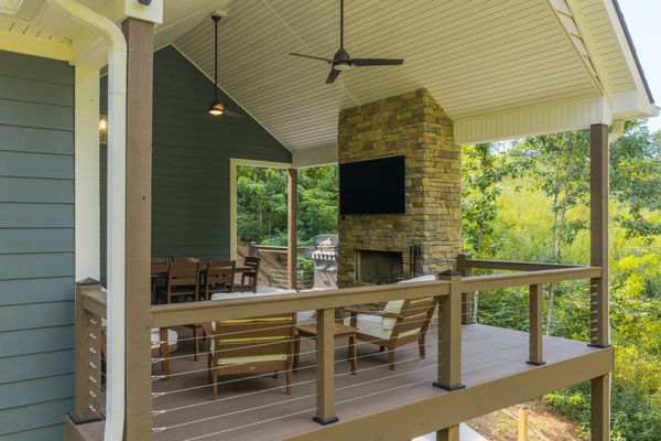 Main level deck seating area, fireplace, and TV
