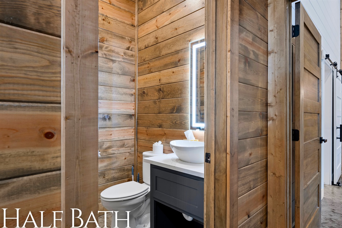 Half bath with modern farmhouse style for convenience.