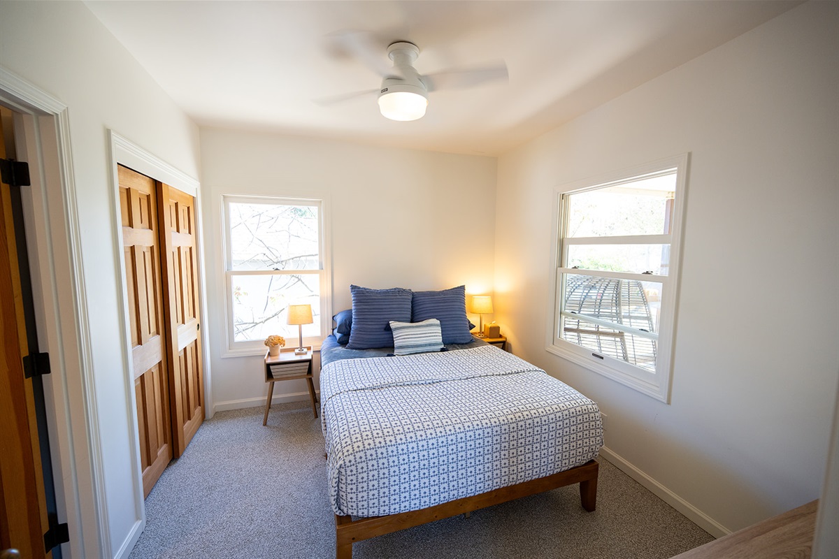 Comfortable bedroom featuring a queen bed, soft linens, and a calm setting for a restful night’s sleep