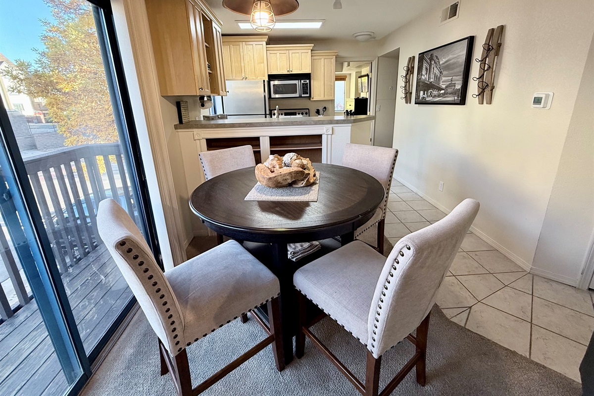 Dining overlooks sliding glass doors, and brings in lots of natural light