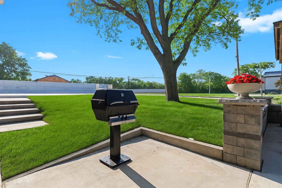 Relax and cook outdoors at the on-site grill station, surrounded by well-kept landscaping.