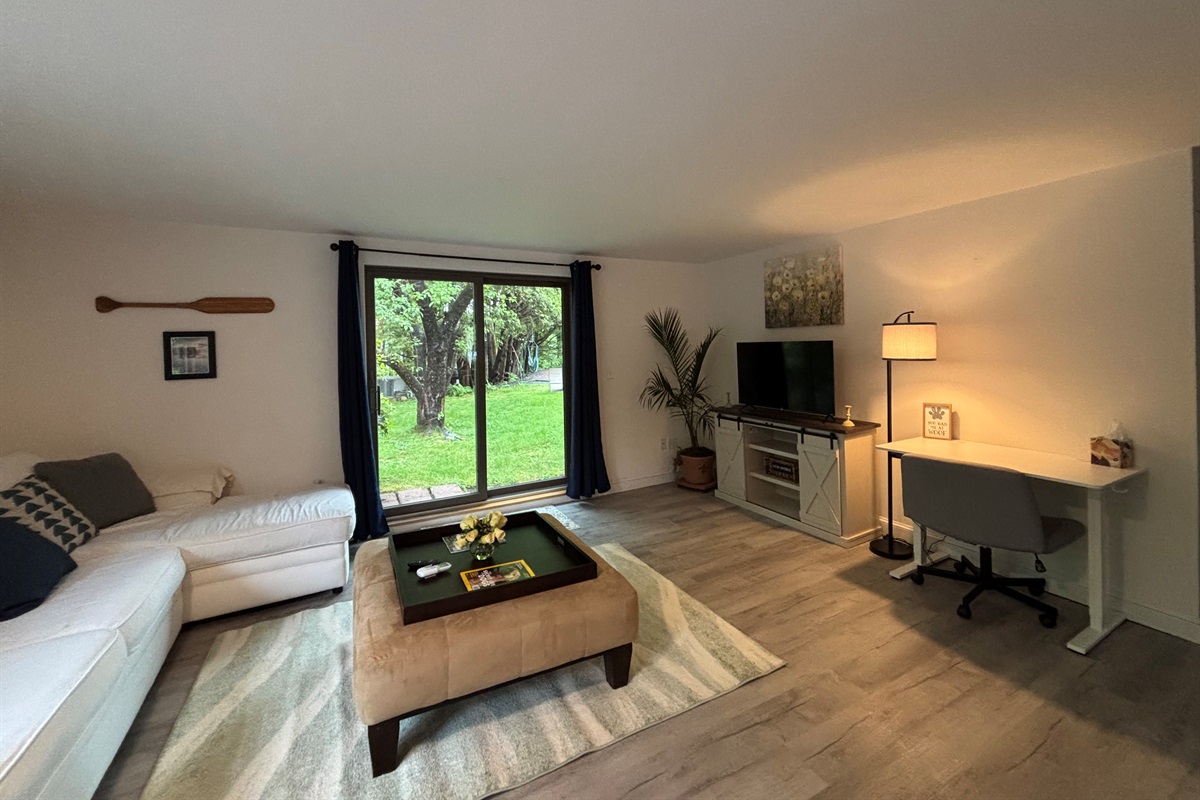 Living area with slider to pool and lake views