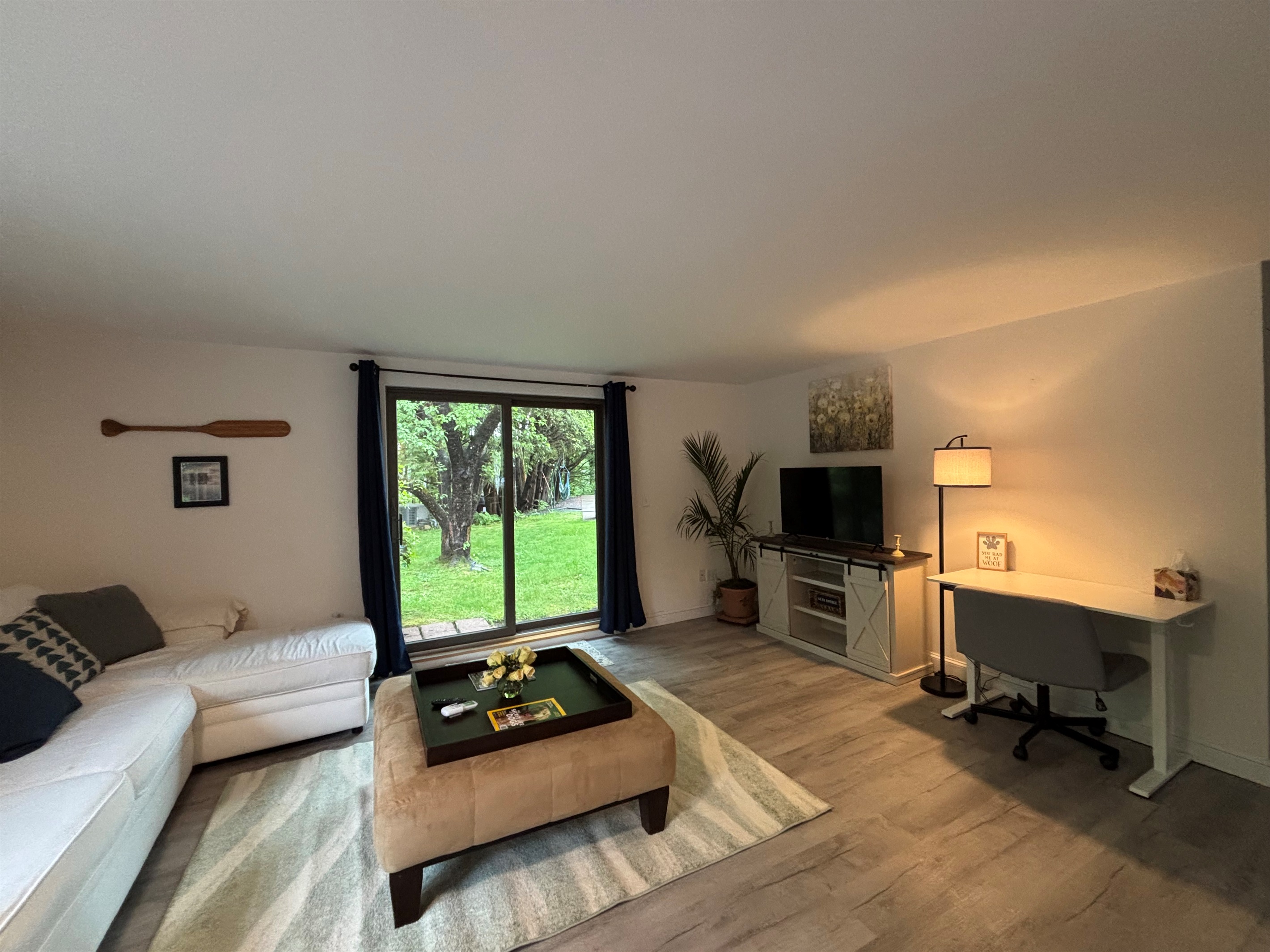 Living area with slider to pool and lake views