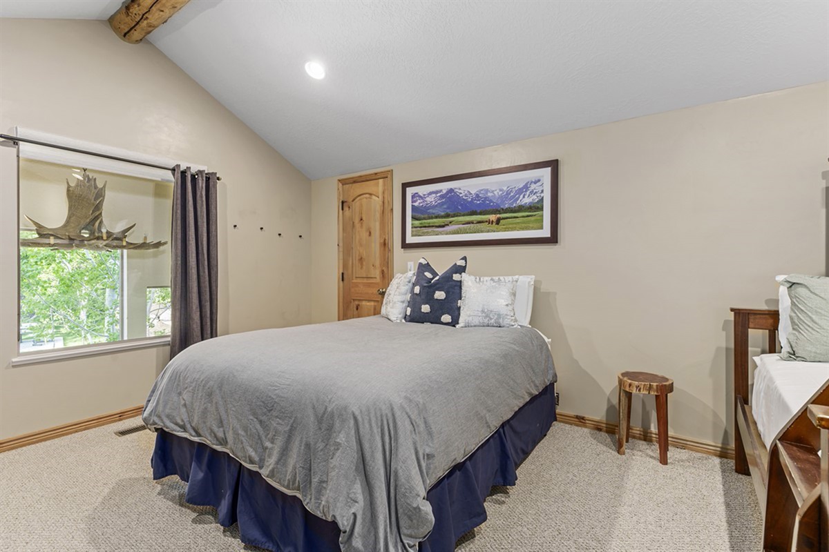 Cozy guest bedroom with soft light and a relaxing, peaceful feel.