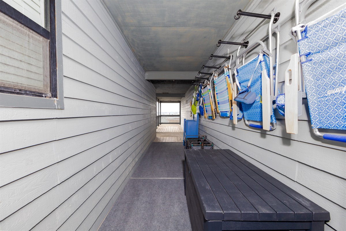 Exterior entryway stocked with beach supplies