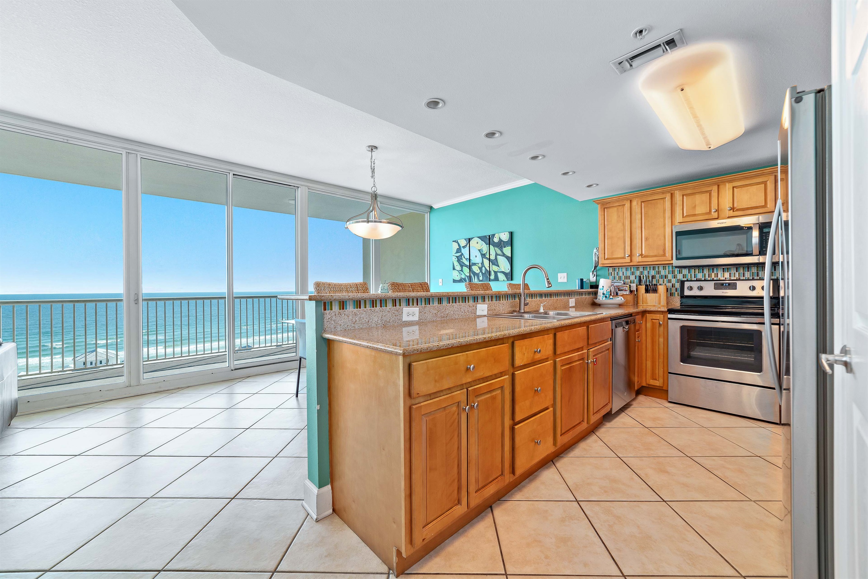 Seamlessly blending indoor living with stunning outdoor vistas, this open-concept condo features spacious seating, a modern kitchen, and an expansive balcony overlooking the pristine coastline. Your ideal coastal retreat awaits.